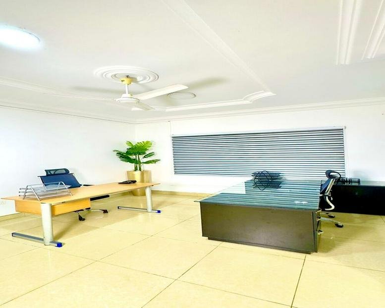 Spacious executive office at Abotsi Street, East Legon, Accra, Ghana with dual desks and natural light.