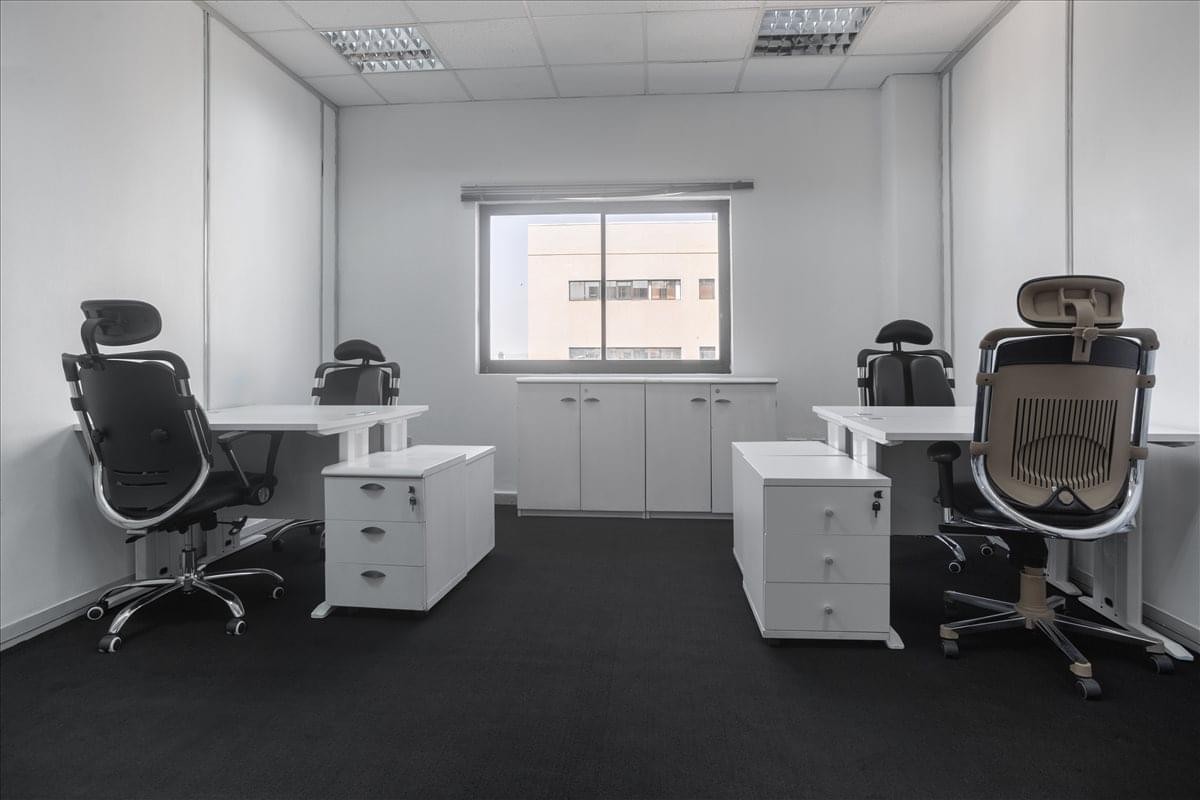 Spacious two-person office suite with white desks and black ergonomic chairs at Rivers House.