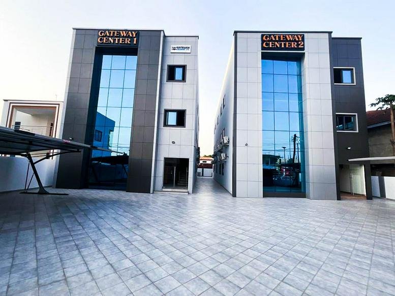 Exterior view of the modern glass-facade Gateway Centers in East Legon.