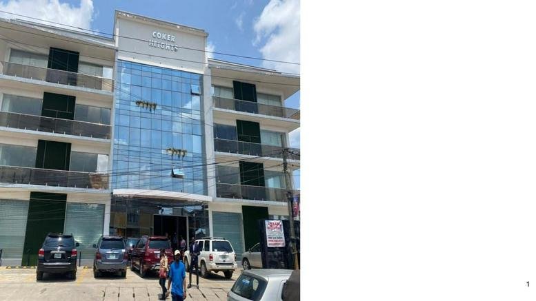 Exterior view of the multi-story glass and white facade building at Ilupeju, Lagos, Nigeria.