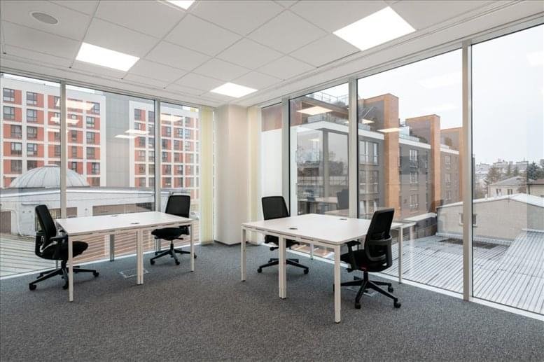 Open-plan workspace with large windows and city views.