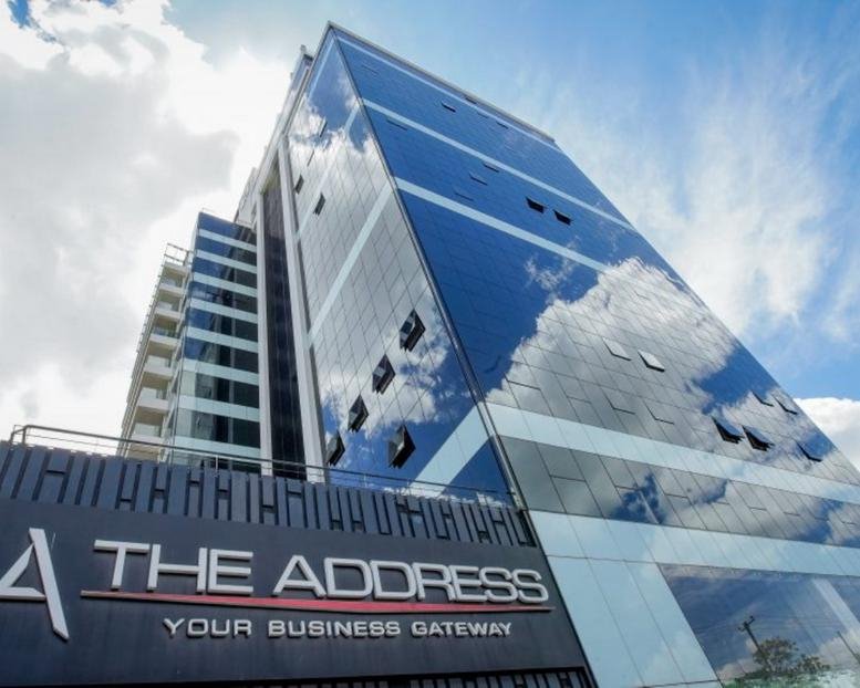 Exterior view of the glass-facade The Address building with cloud reflections.