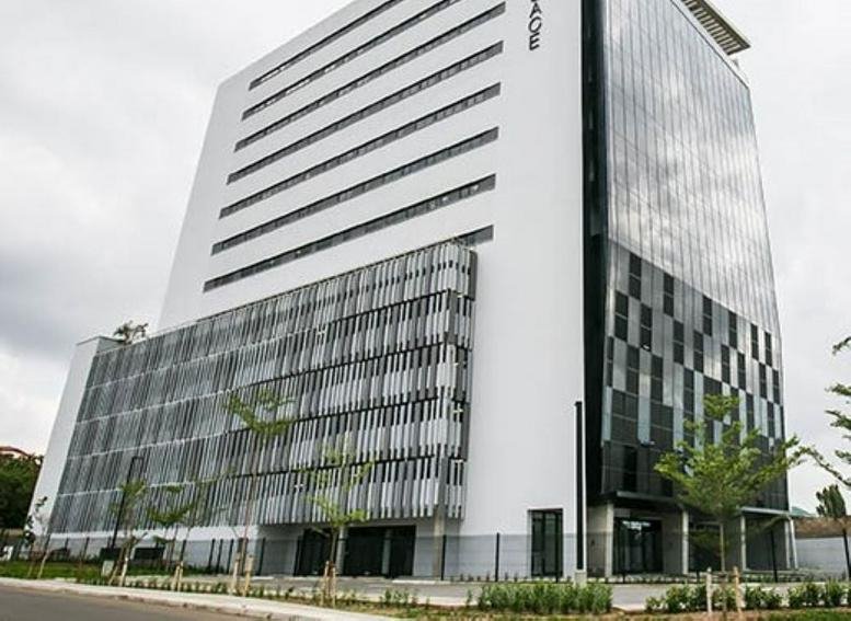 Exterior view of the white and glass-facade North Dzorwulu building in Airport Area, Accra.