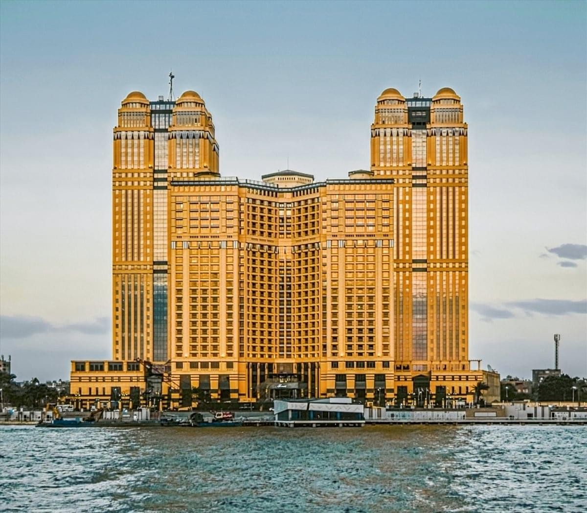 Exterior view of the majestic Nile City Towers overlooking the water.
