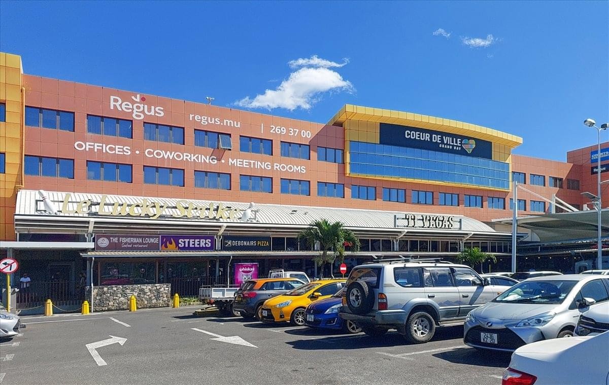 Exterior view of the Coeur De Ville Complex with its distinctive orange facade and retail ground floor.