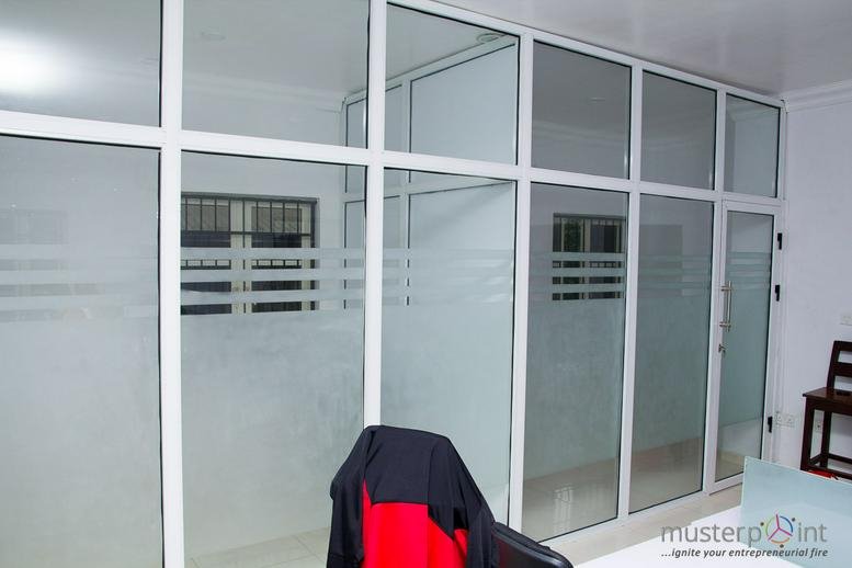 Spacious interior office space with frosted glass partitions at 1 Adekunle Owobiyi Close.
