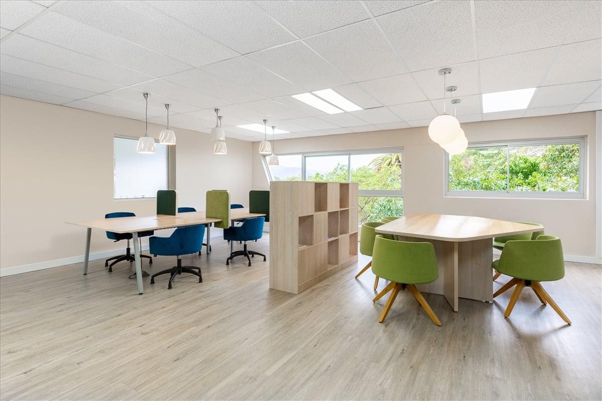 Spacious coworking area at 1 New Street (2nd Floor), Paarl, Cape Town with wooden floors and colourful seating.