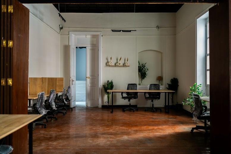 Spacious open-plan office at The Circle, 15 Ali Zou Al Fekar, with wooden flooring and multiple workstations.