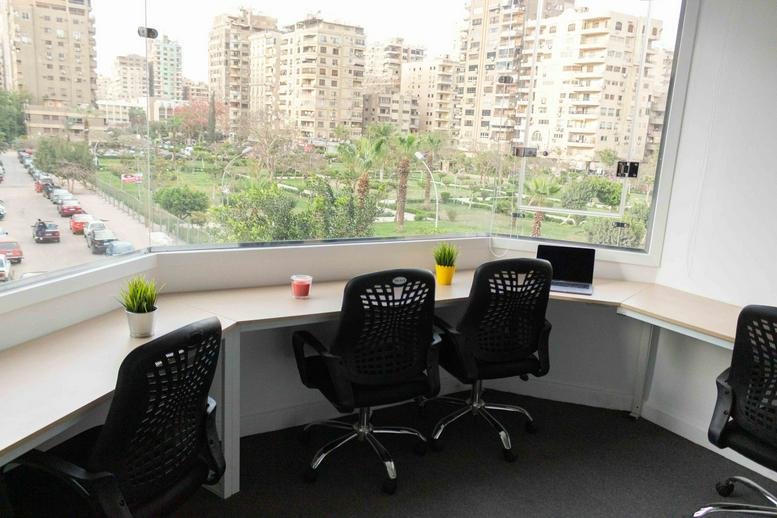 Bright workspace at 15 Sakaliya Street, Makram Ebeid, Nasr City, Cairo with window desks overlooking a green park.