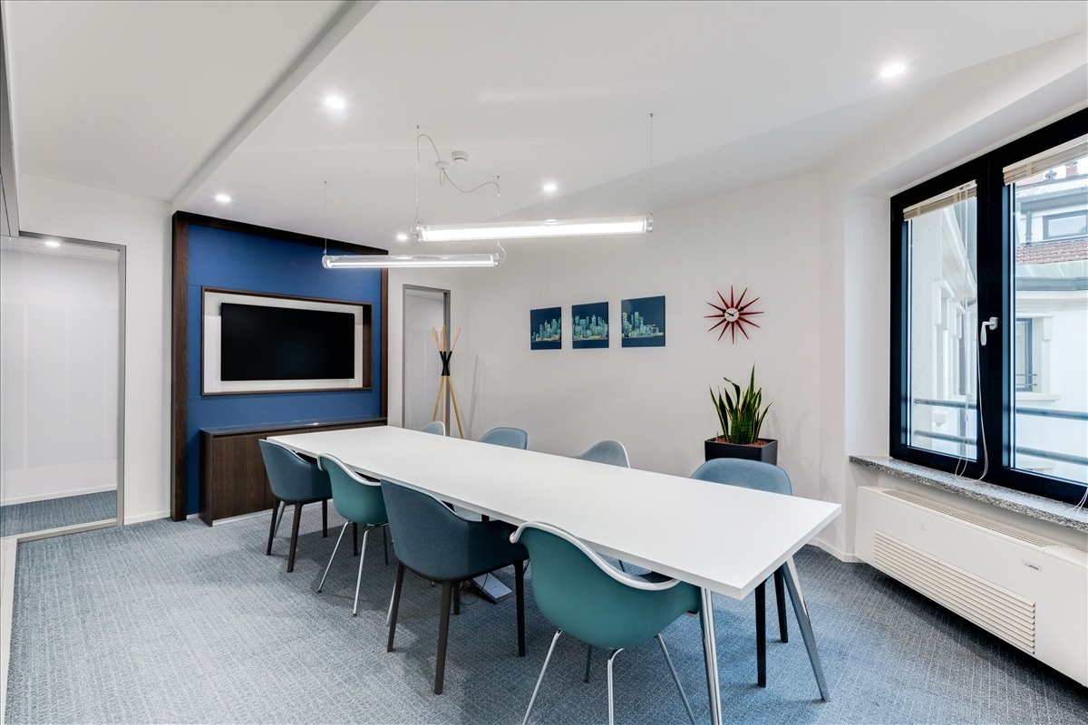 Professional meeting room at 17 Ahram Street, Heliopolis, Cairo, Egypt with a blue feature wall and white table.