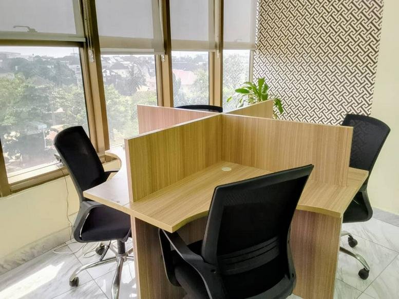 Bright workspace at Huddle Workspaces, 2 Rev. Ogunbiyi Street with partitioned desks and large windows.