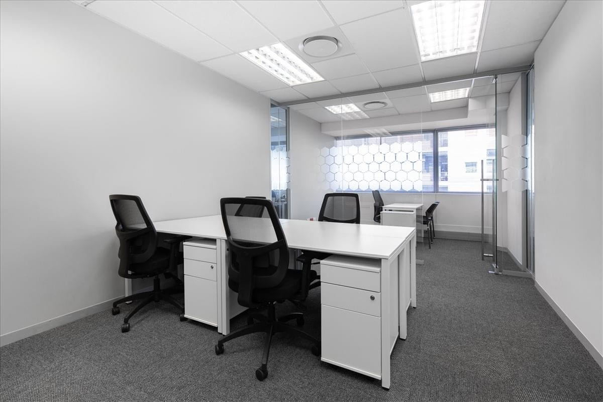 Exterior view of the tiered white office building at 21 Dreyer Street.