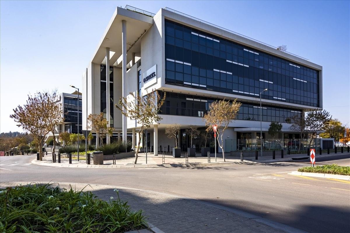 Exterior view of the modern glass and concrete Pegasus Building 1 at 210 Amarand Avenue.