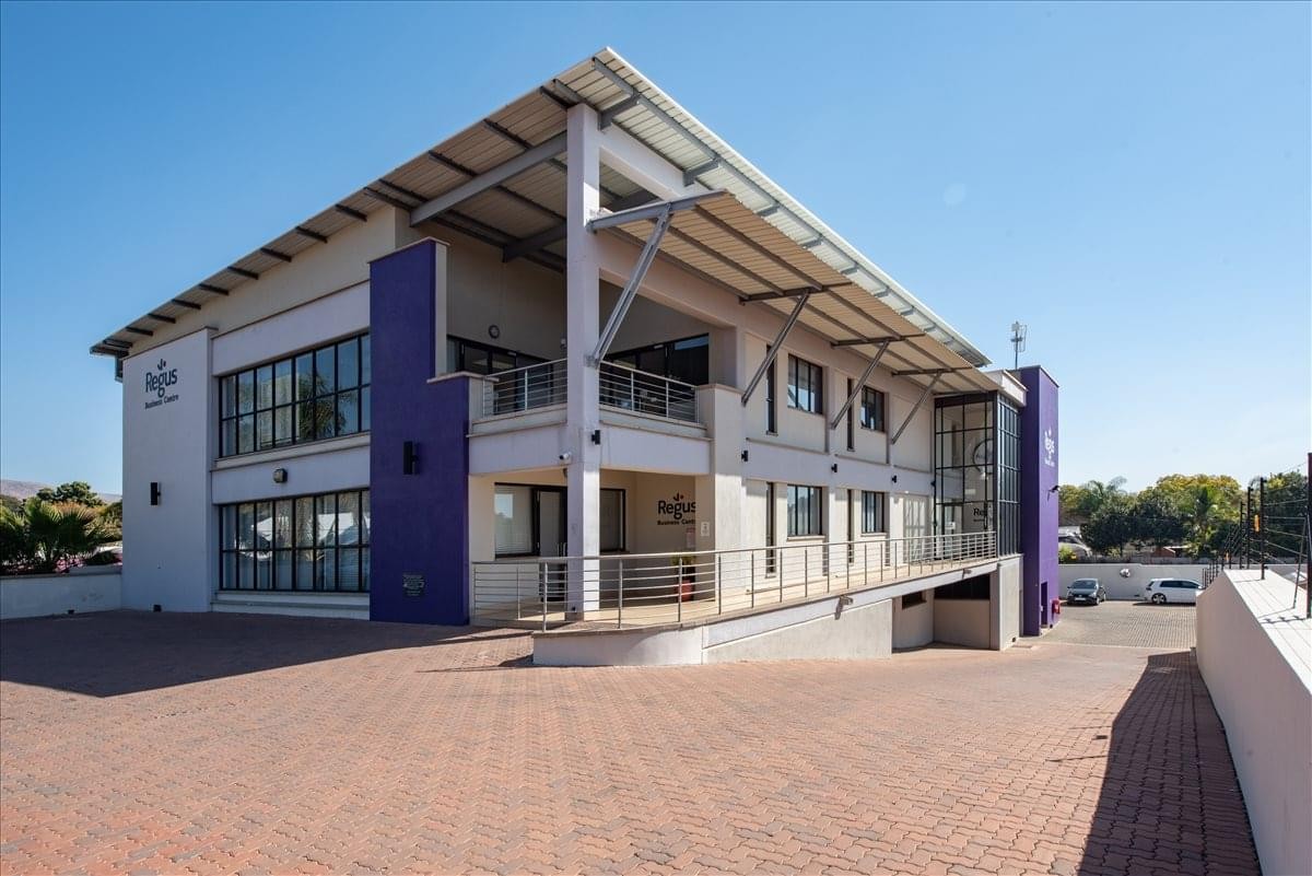 Modern exterior of 214 Beyers Naude Drive with purple accents and a metal roof structure.