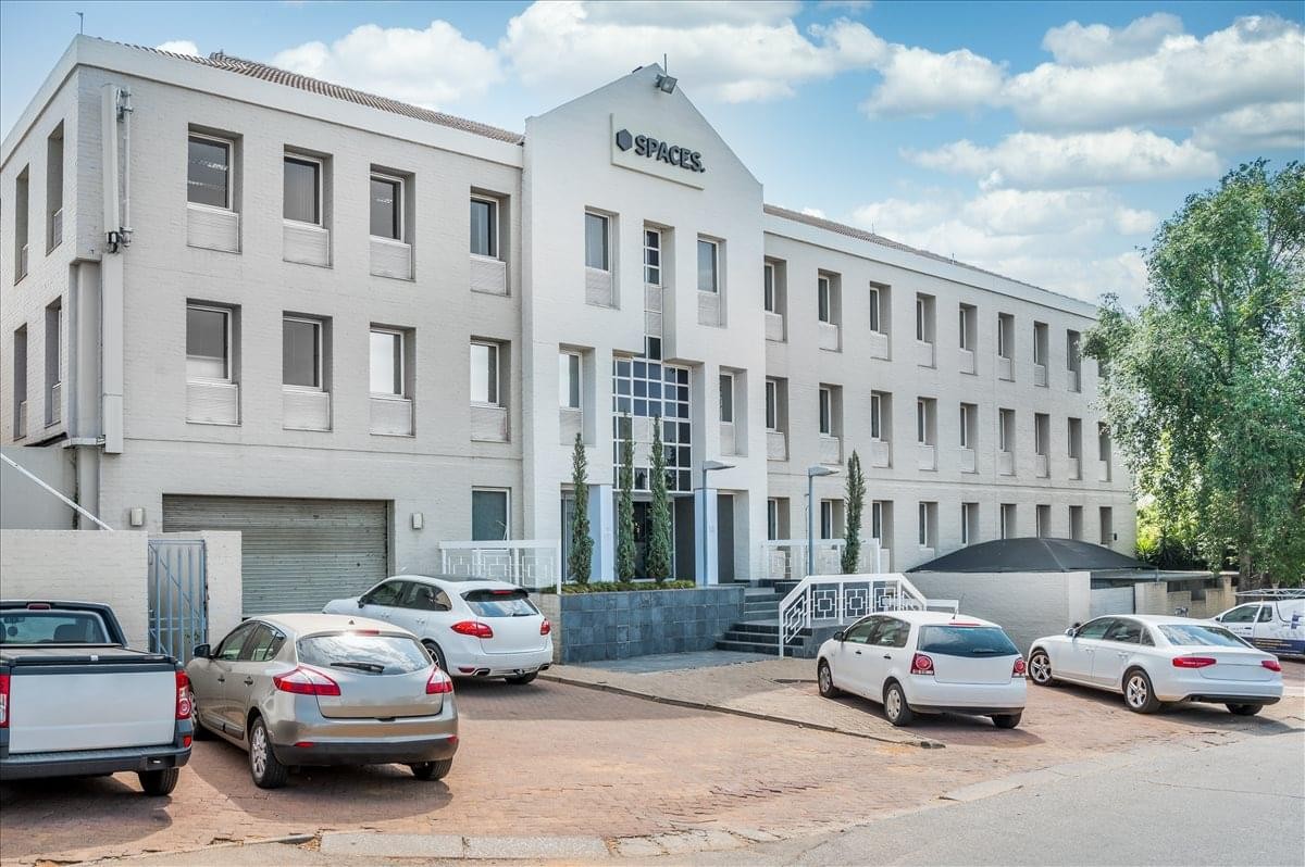 Exterior view of the multi-story white office building at 377 Rivonia Boulevard.