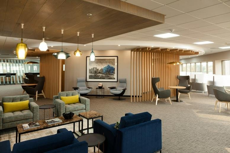 Spacious communal lounge at 61 Katherine Street, 1st Floor, Sandton with designer lighting and plush seating.