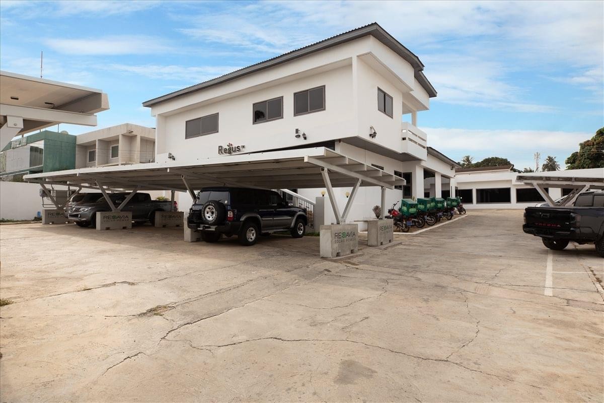 Exterior view of the white multi-story office building at 19 Aviation Road, Airport Residential Area, Accra, Ghana.