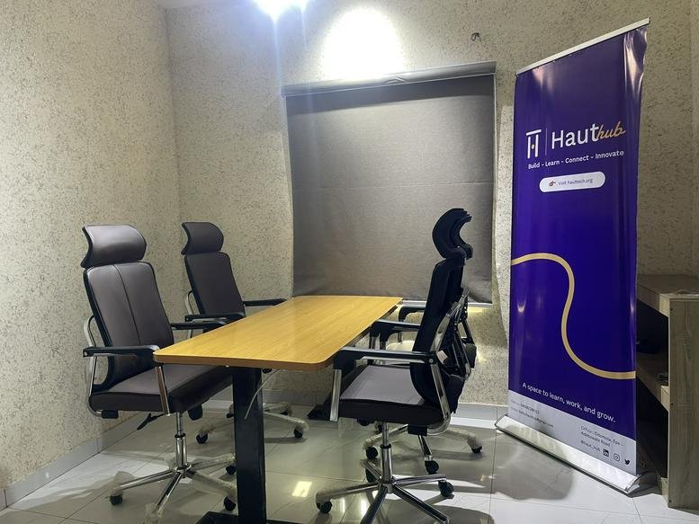 Private office suite with a wood-topped desk and ergonomic chairs.
