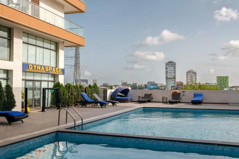 The Signature Apartments, Boundary Road, Accra, Ghana featuring an outdoor rooftop swimming pool and lounge area.