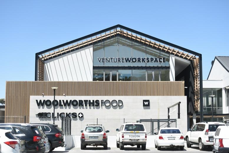 Exterior view of the modern Constantia Emporium building with retail storefronts and upper-level workspace.