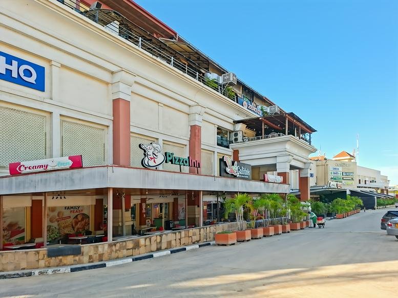 Exterior view of the white City Mall Nyali building facade from the street.
