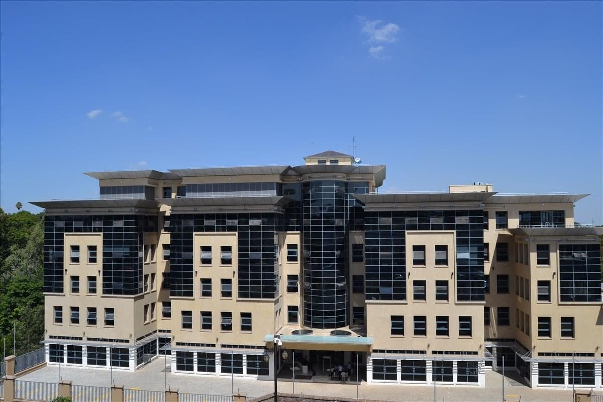 Wide exterior view of the multi-story Eaton Place building under a clear blue sky.