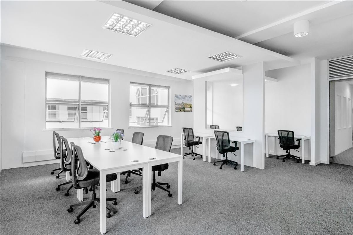 Spacious open-plan workspace at Laiboni Centre with white desks and natural light.