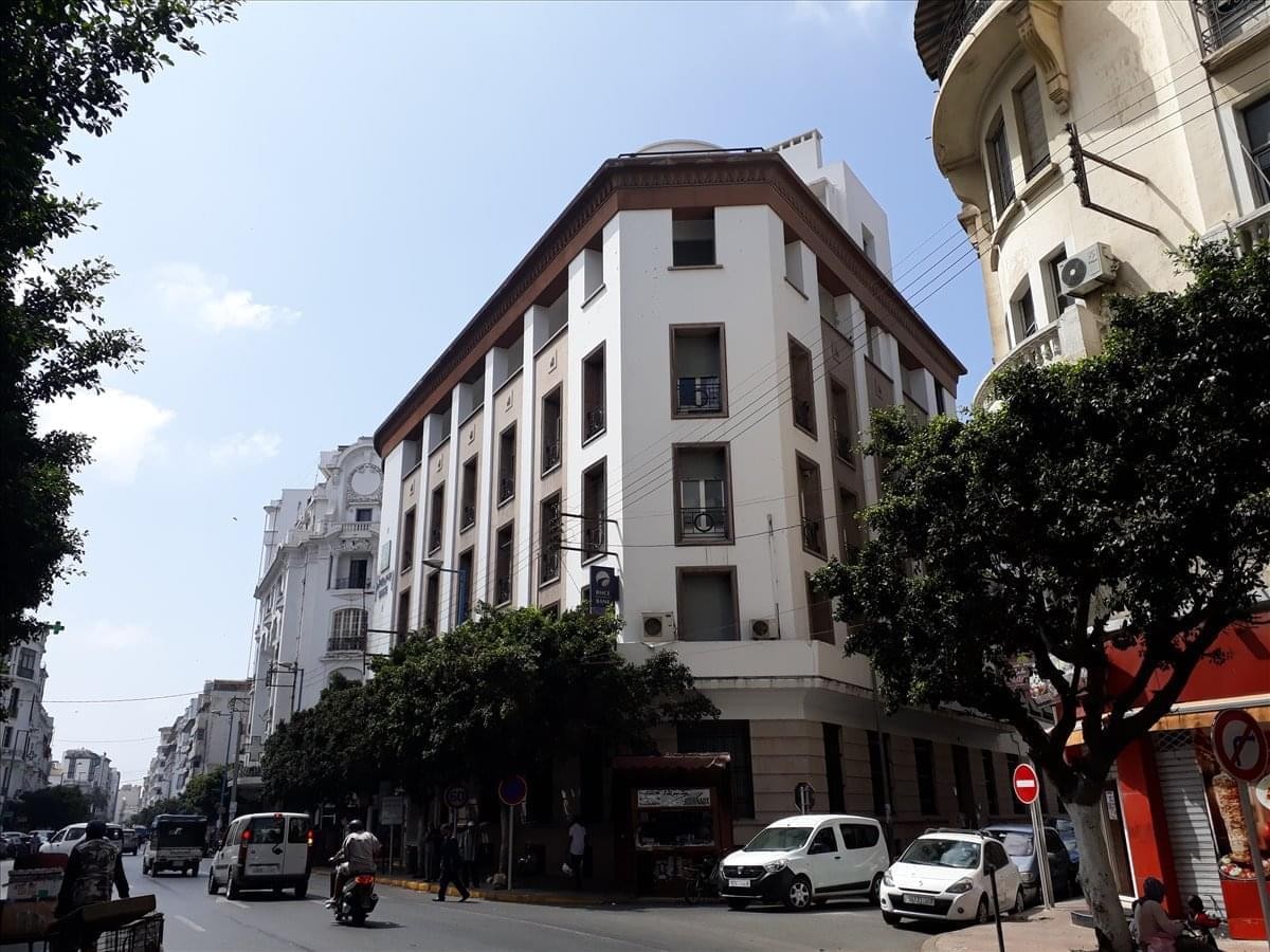 Exterior view of the white corner building on Lalla Yacout Avenue, Casablanca, Morocco.