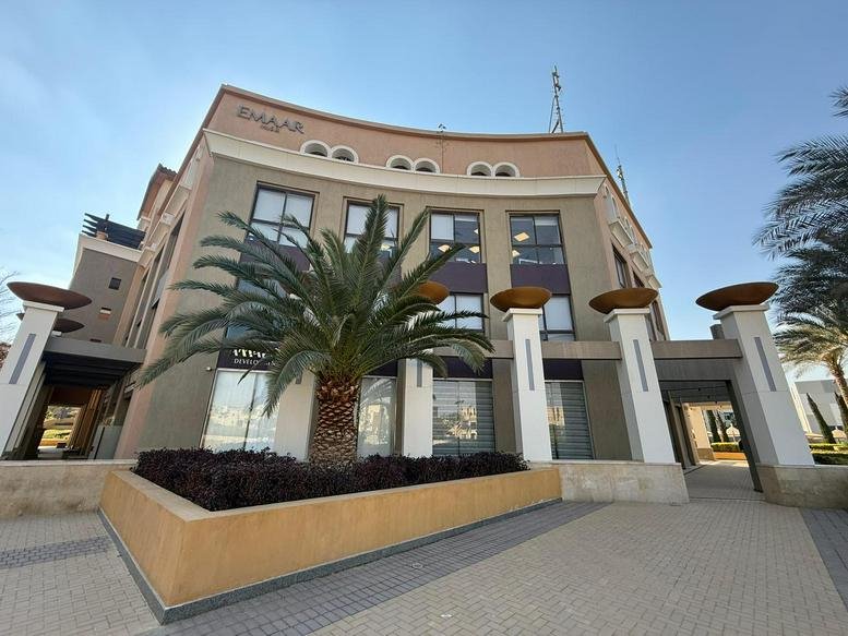 Exterior view of the modern stone-clad facade at Mivida Business Park, Mivida, New Cairo, Egypt.