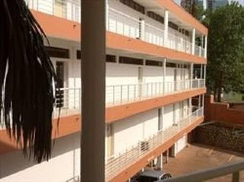Exterior view of Mukwasi House building with multiple floors and balconies.