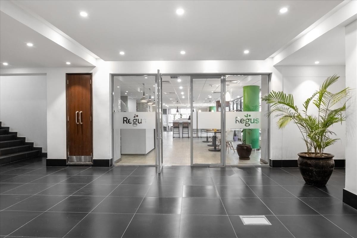 Professional building entrance of Westlands Office Park featuring glass doors and indoor plants.