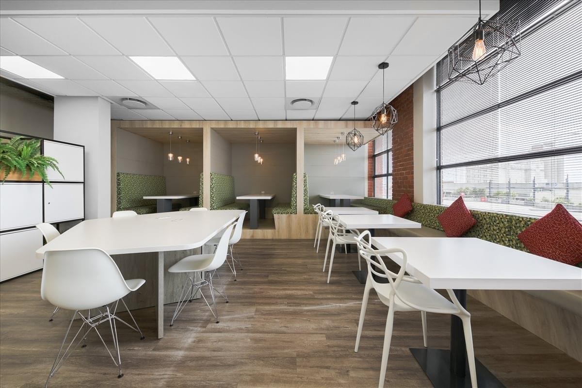 Spacious communal breakout area at North Park, Black River Park with modern dining tables and booth seating.