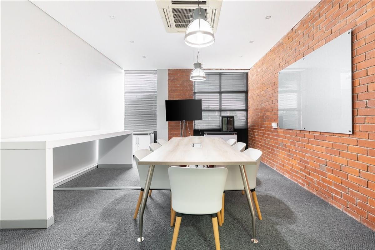 Meeting room at North Park, Black River Park featuring a brick wall and white board.