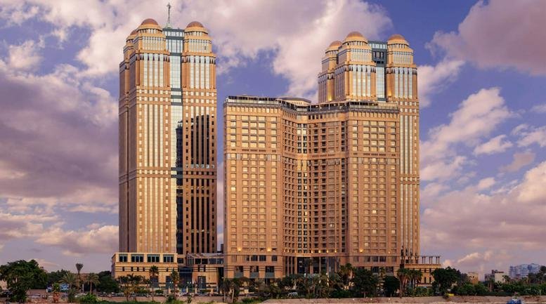 Exterior view of the twin towers at Nile City Towers along the riverfront.