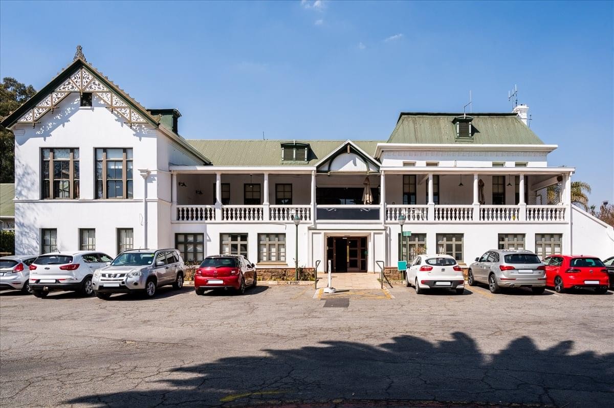 Exterior view of the historic white building at 1 Casino Road, Foundershill Estate.