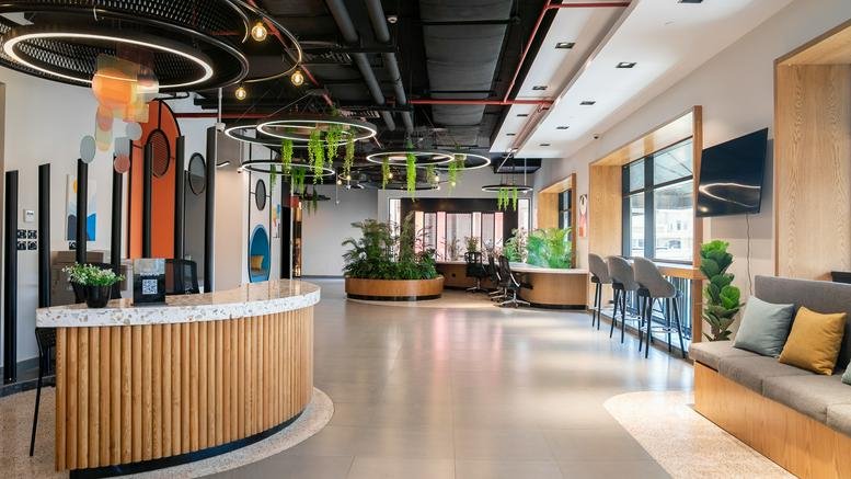 Spacious reception area with a curved wooden desk and modern ring lighting at Gateway Mall.