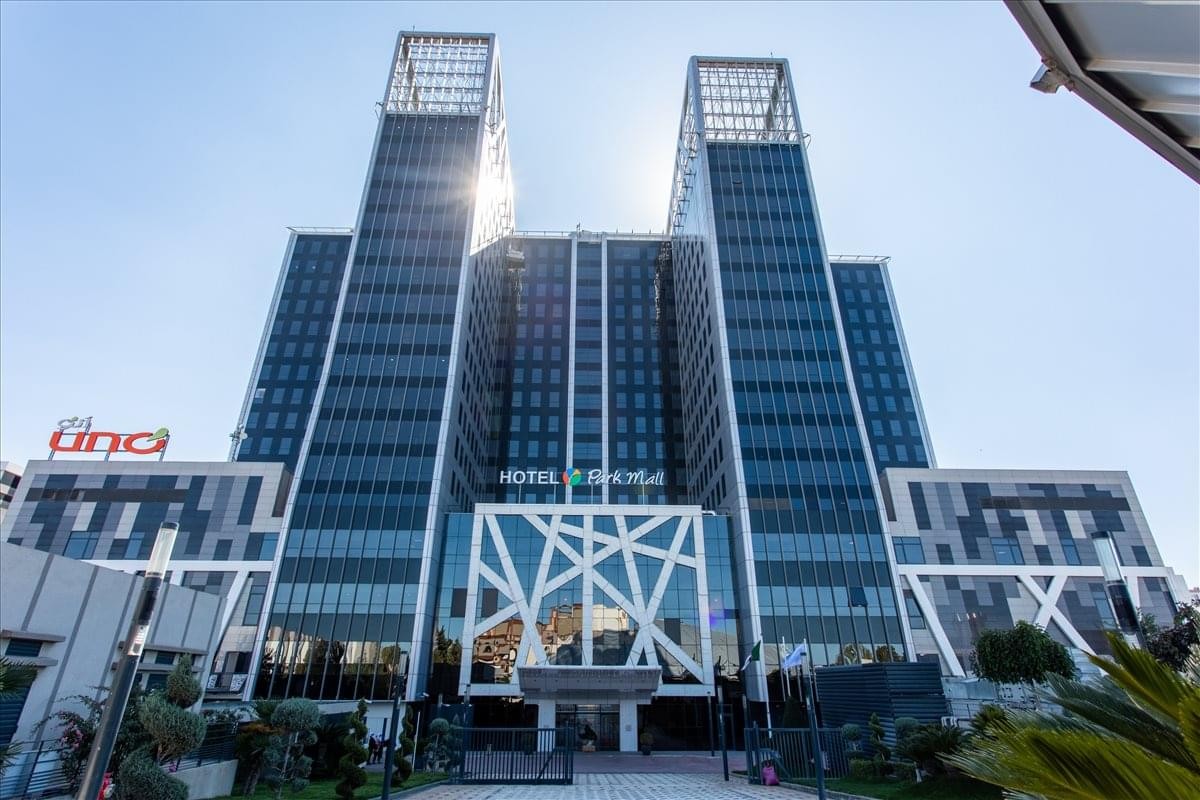 The modern glass and steel exterior facade of the Parc Mall building in Setif.