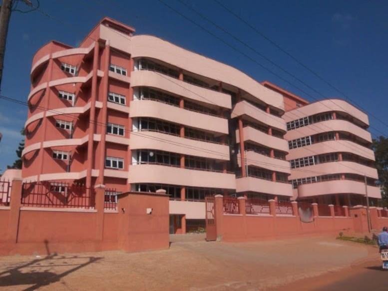 Exterior view of the curved red and white building facade at Plot 23 Lumumba Avenue.