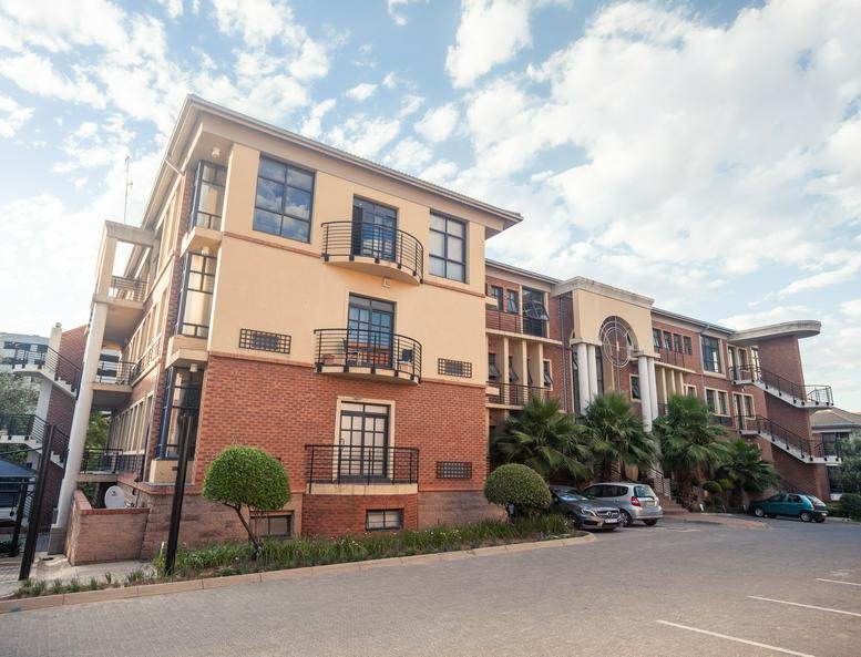 Exterior view of the multi-story brick and cream facade at Prism Business Park.