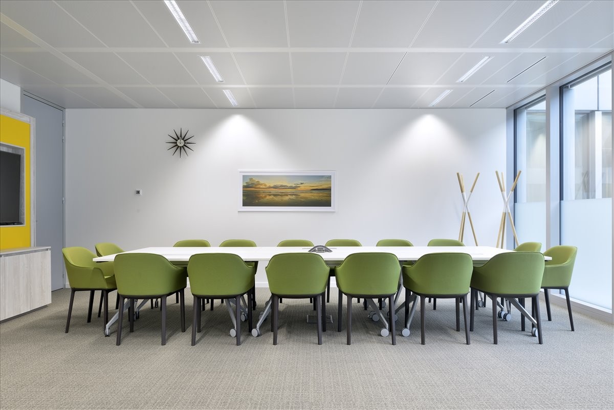 Spacious boardroom at Purshottam Place, Chiromo Road, Westlands, with green chairs and a long white table.