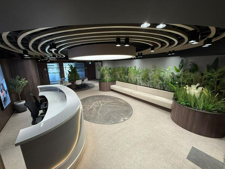 Wide-angle view of the modern reception at Enawalks, South 90th Street, New Cairo, Egypt with a curved white desk.