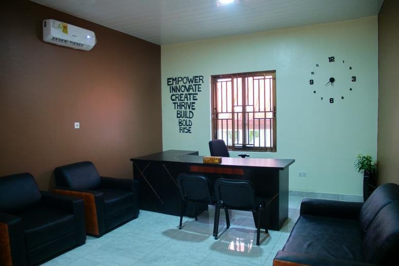 Private office at SheRise Hub, Ashale Botwe, Madina, Accra, Ghana featuring leather chairs and a large desk.