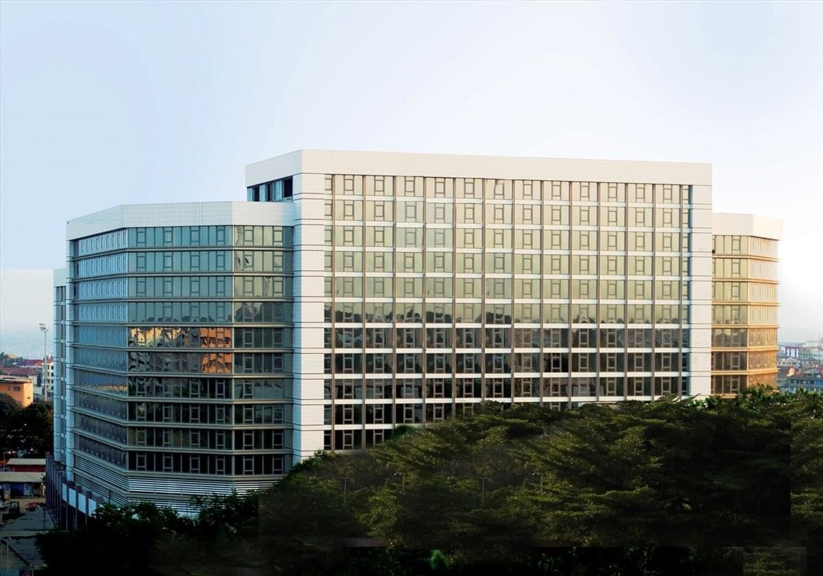 Exterior view of the multi-level glass and white facade of The Octagon, Barnes Road.