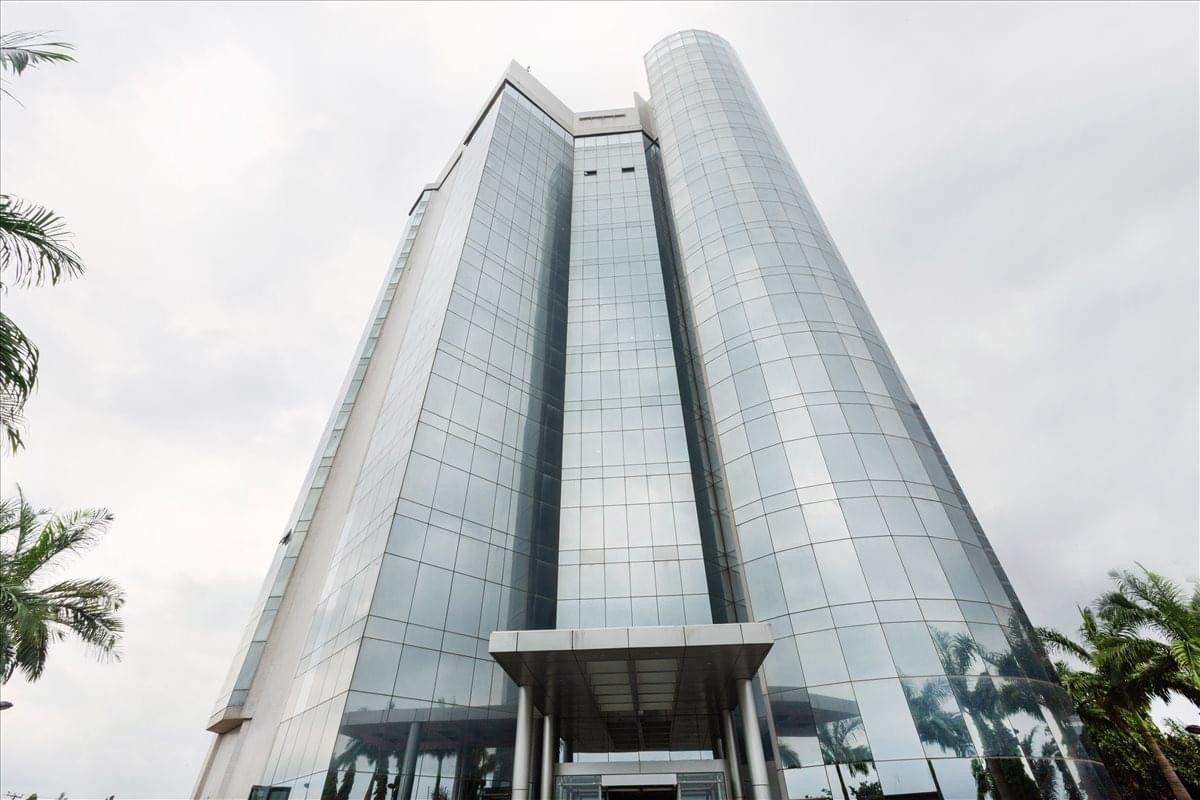Exterior view of the glass-facade Tower C Churchgate Plaza under a bright sky.