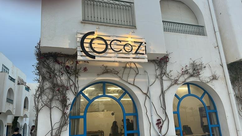 White exterior facade of Marina Djerba, Unit C10, Port de Plaisance, Houmt Souk with blue arched windows.