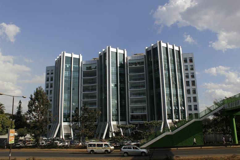 Exterior view of the multi-towered glass facade of West End Towers against a blue sky.