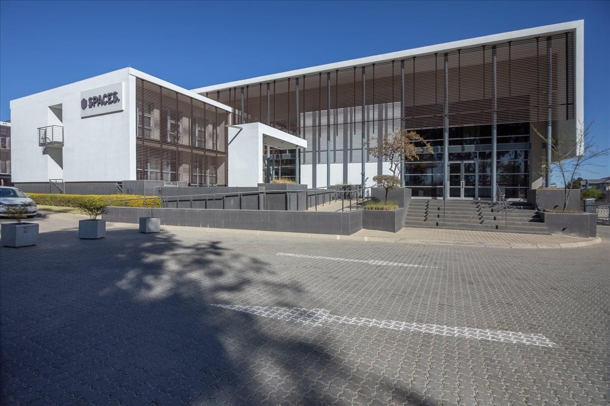 Modern exterior of Willow Wood Business Park featuring a clean white facade and large glass windows.