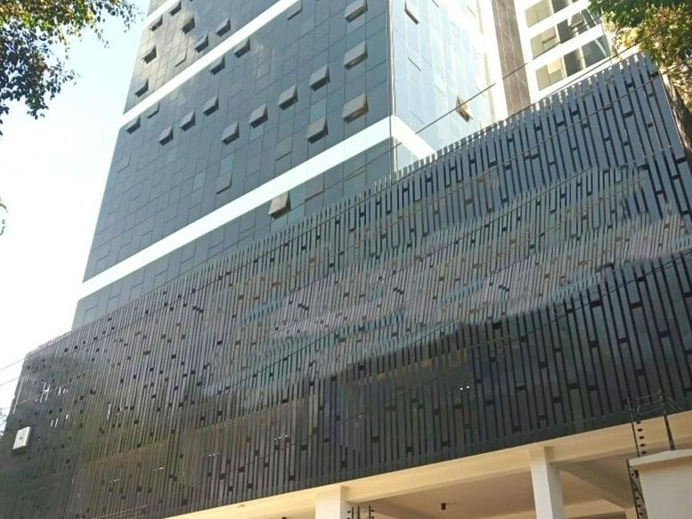Low-angle exterior view of the modern dark-paneled facade of The Address.