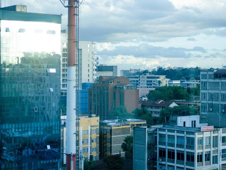 City skyline view of the contemporary Victoria Plaza, Parklands Road building facade under a cloudy sky.